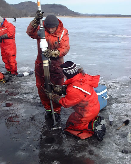 USGS scientist Pete Boma and Jennifer Cavanaugh retrieve ice core to obtain sediment samples for the nitrogen project.